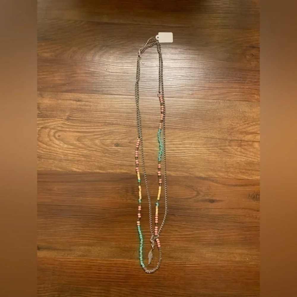 Silver tone beaded necklace with wooden, pink and turquoise colored bead…